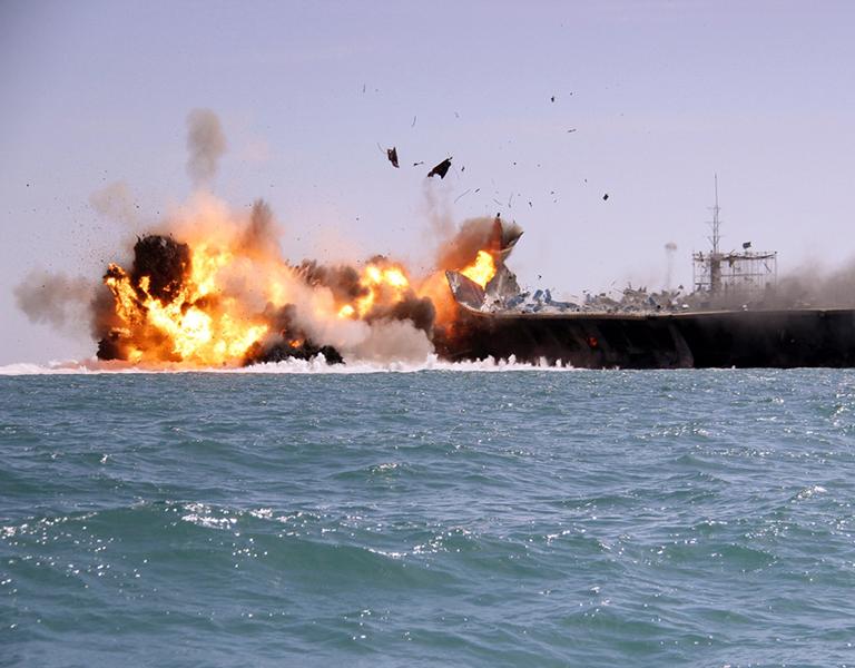 A tanker is destroyed as a test target during an Iranian naval exercise