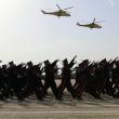 Iraqi forces marching, helicopters overhead