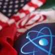A photo illustration shows US and Iranian flags and an atomic symbol - source: Reuters