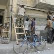 Syrian men attempt to repair electrical lines damaged by forces loyal to the Assad regime in 2013 - source: Reuters