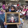 A Syrian woman holds a portrait of her missing son during a protest against the Assad regime in 2012 - source: Reuters