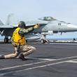 Photo of an F-18 fighter jet launching from a U.S. aircraft carrier.