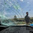 Oscar-winning Palestinian Director Basel Adra checks a damaged car after Israeli settlers' attack in Susiya in the Israeli-occupied West Bank - source: Reuters