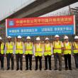 Chinese engineers pose in front of a sign announcing a Belt and Road Project construction project - source: China State Engineering Corp (Middle East) LLC