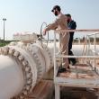 Photo of workers at a natural gas pipeline in Syria.