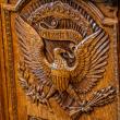 A carving of the Great Seal of the United States on the Resolute Desk in the Oval Office of the White House - source: The White House
