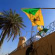 Protesters display Kataib Hezbollah militia flags in Baghdad - source: Reuters
