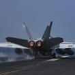 A US Navy F-18 lands on a carrier flight deck - source: Department of Defense