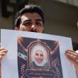 Photo of Syrians holding a memorial protest for family members killed by the former Assad regime.