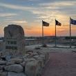 The sun sets behind U.S. and Kuwaiti flags at Ali Al Salem AFB in Kuwait - source: Department of Defense