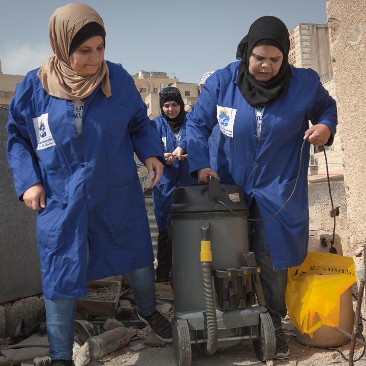 Women plumbers on rooftop