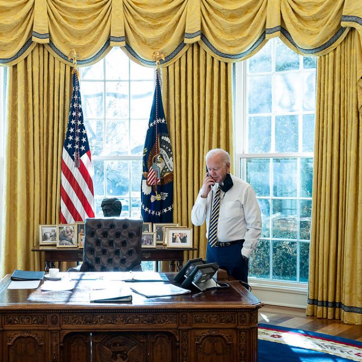 President Joe Biden speaks on the phone in the Oval Office of the White House