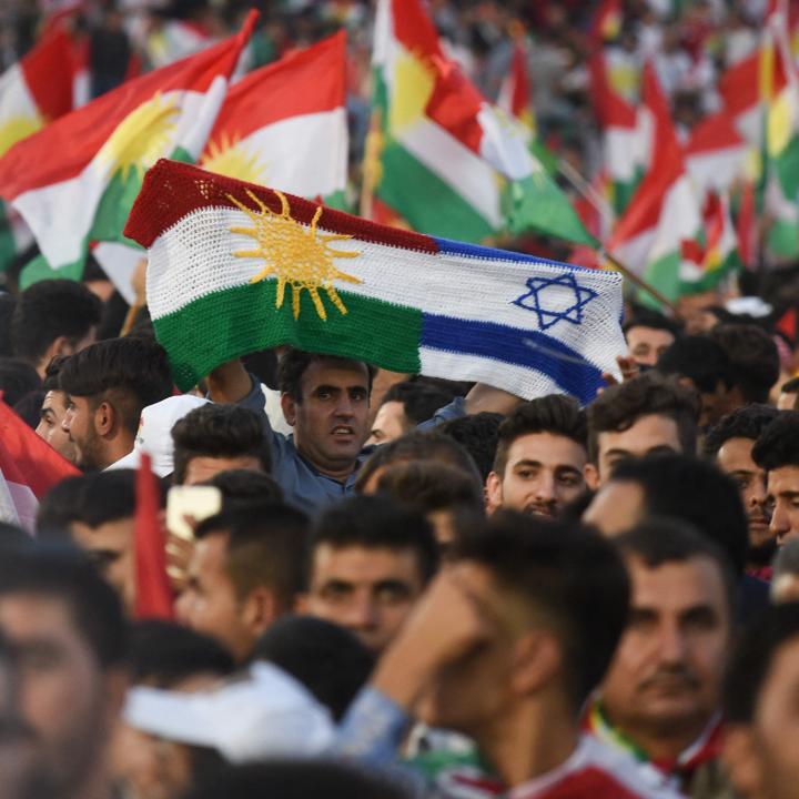Iraqi Kurds display Kurdish and Israeli flags