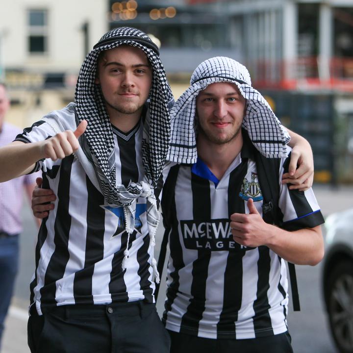 Newcastle United fans celebrate the Saudi purchase of their team