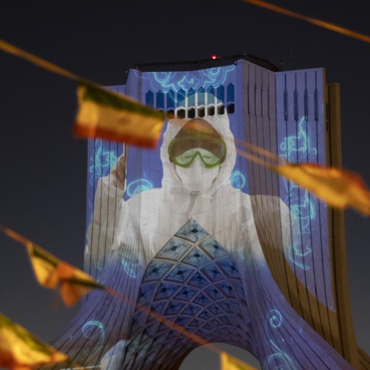 Photo showing the image of a masked nurse projected onto Iran's Azadi Monument.