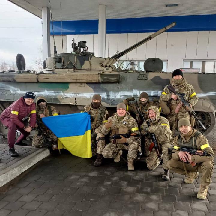 Ukrainian soldiers pose with a captured Russian military vehicle - source: Reuters
