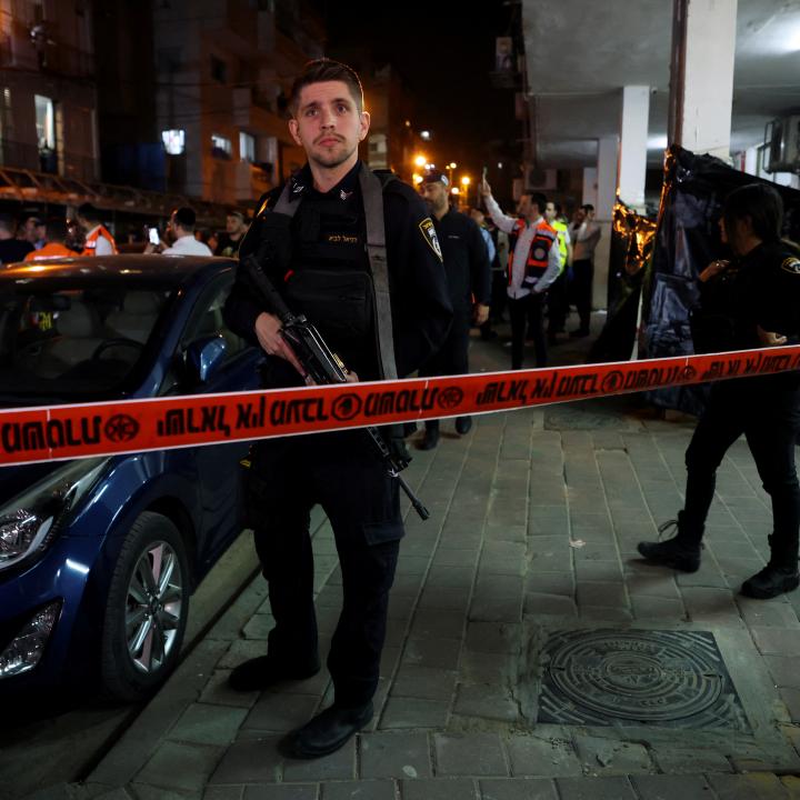 An Israeli security officer stands guard at the scene of a terrorist shooting in Tel Aviv, March 2022.