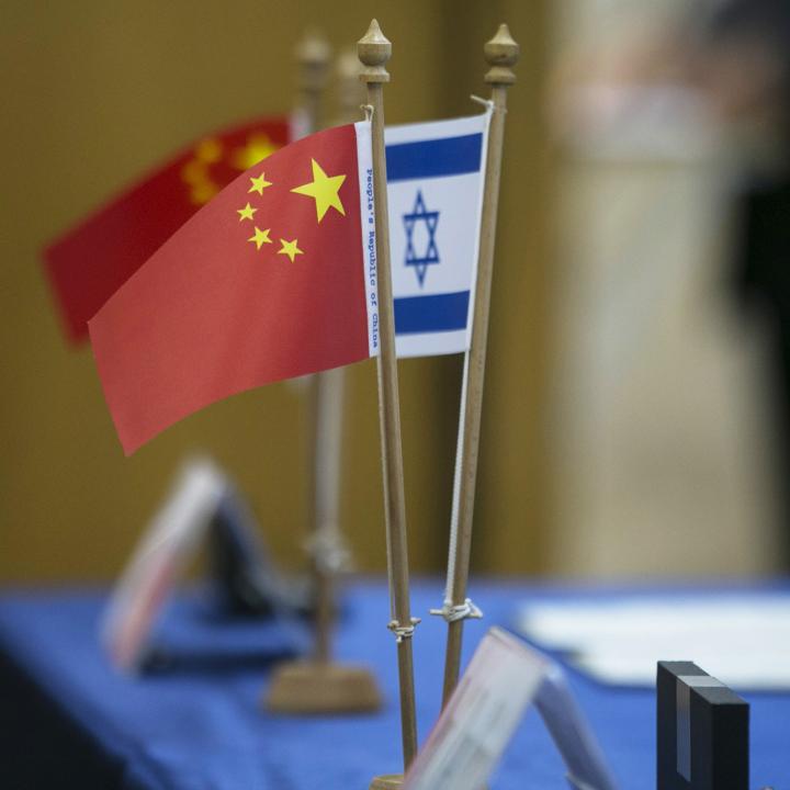 Chinese and Israeli flags on a table at a diplomatic conference - source: Reuters