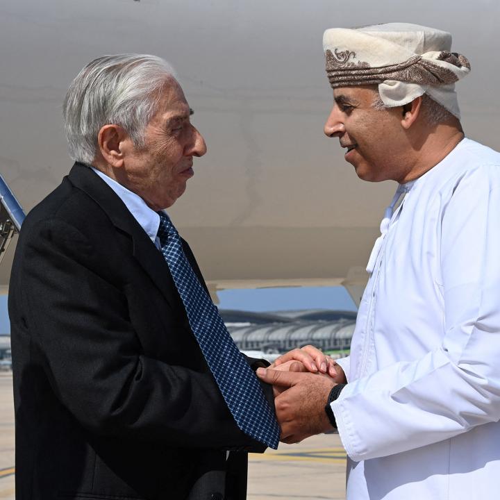 Baquer Namazi, a dual U.S.-Iranian citizen who had been imprisoned in Iran, shakes hands with an Omani official in Muscat - source: Reuters