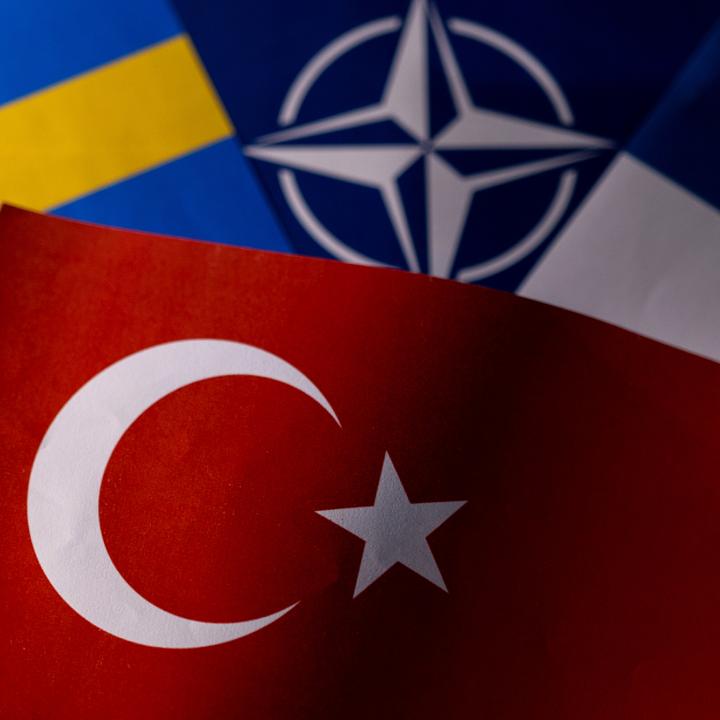 Photo illustration of the flags of Sweden, NATO, Finland, and Turkey - source: Reuters