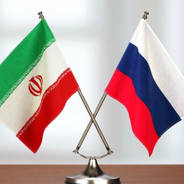 Iranian and Russian flags on a table