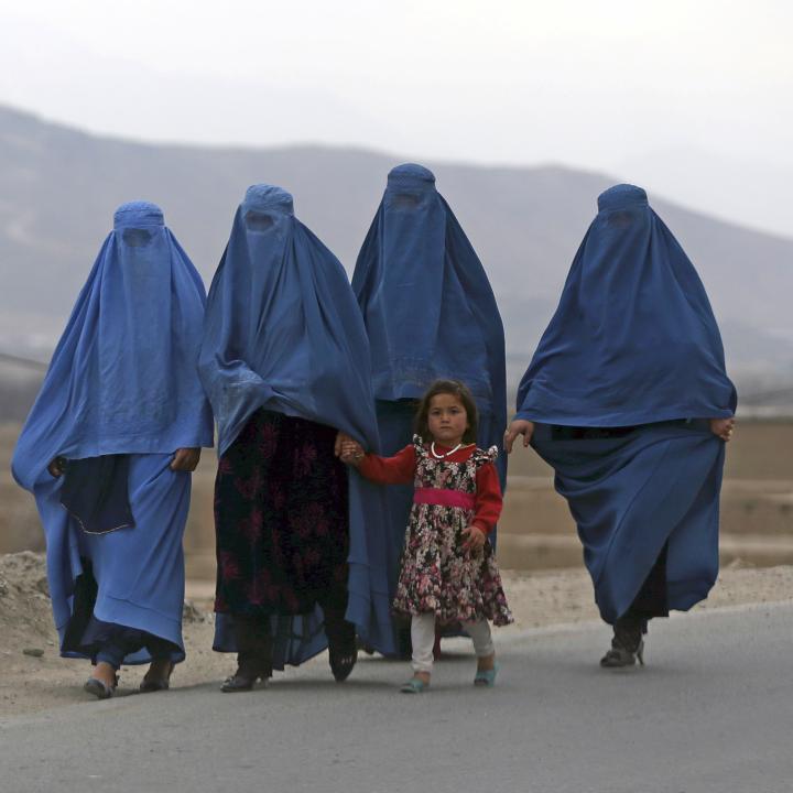 Women and a child walk near Kabul, Afghanistan - source: Reuters