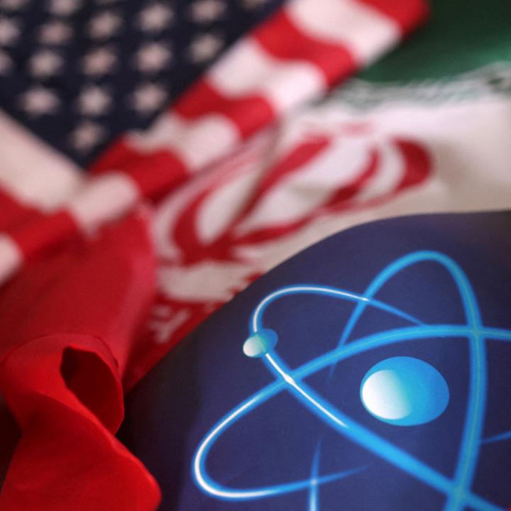 A photo illustration shows US and Iranian flags and an atomic symbol - source: Reuters