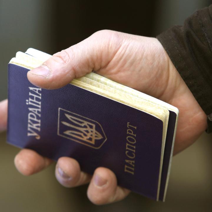 A refugee from the Russian invasion of Ukraine holds a Ukrainian passport - source: Reuters