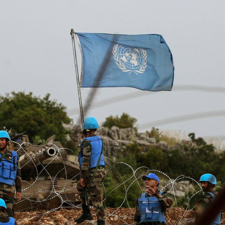 Photo showing an Israeli tank and UN peacekeeping forces on the border with Lebanon.