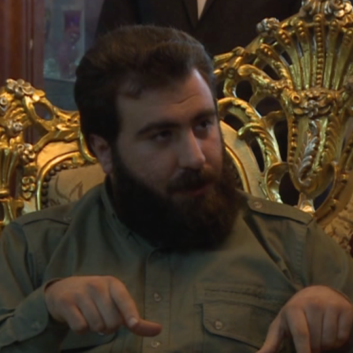 Rayan al-Kildani in a gaudy fake gold chair