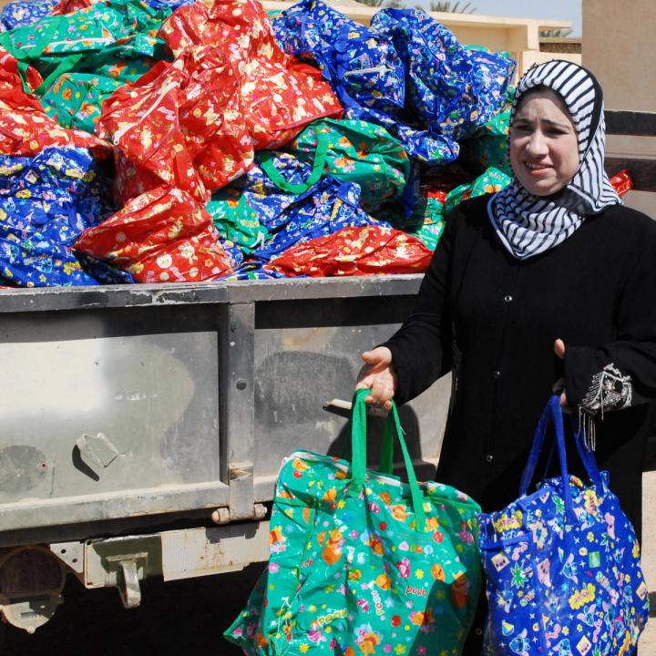 Member of the Ramadi Widows Outreach Assistance Program distributes food packages in Anbar Province