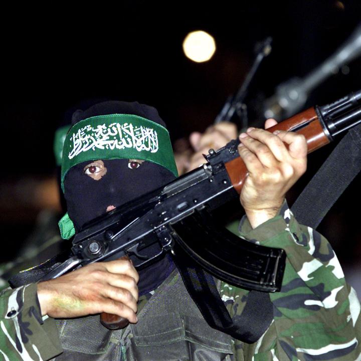 A masked Hamas fighter brandishes a rifle in Gaza - source: Reuters