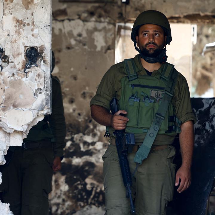 Photo of an Israeli soldier in the ruins of a kibbutz following the October 2023 Hamas attack.