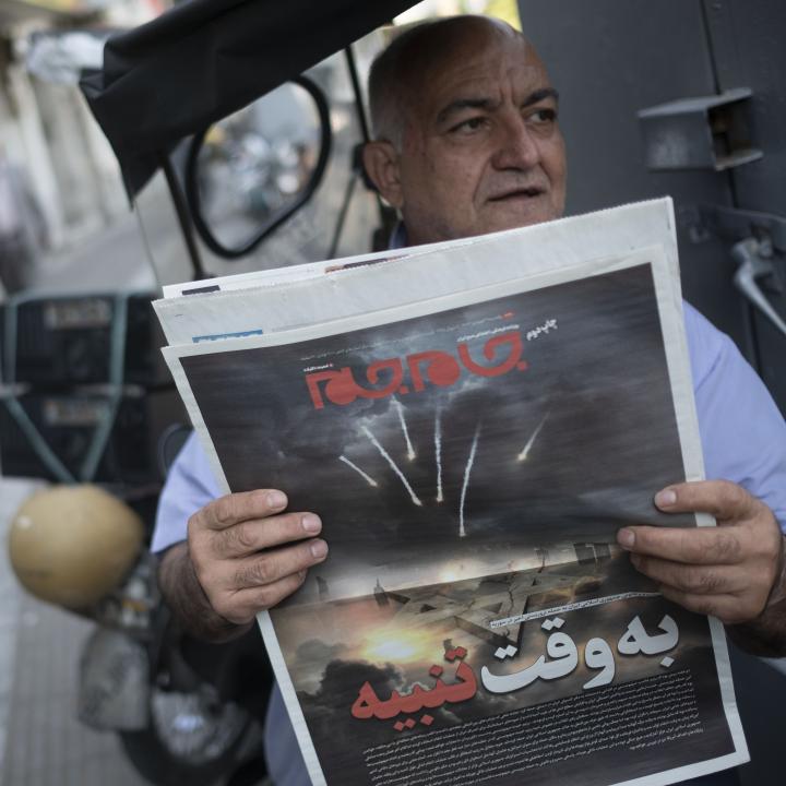 An Iranian man holds a newspaper depicting the April 14 attack on Israel.