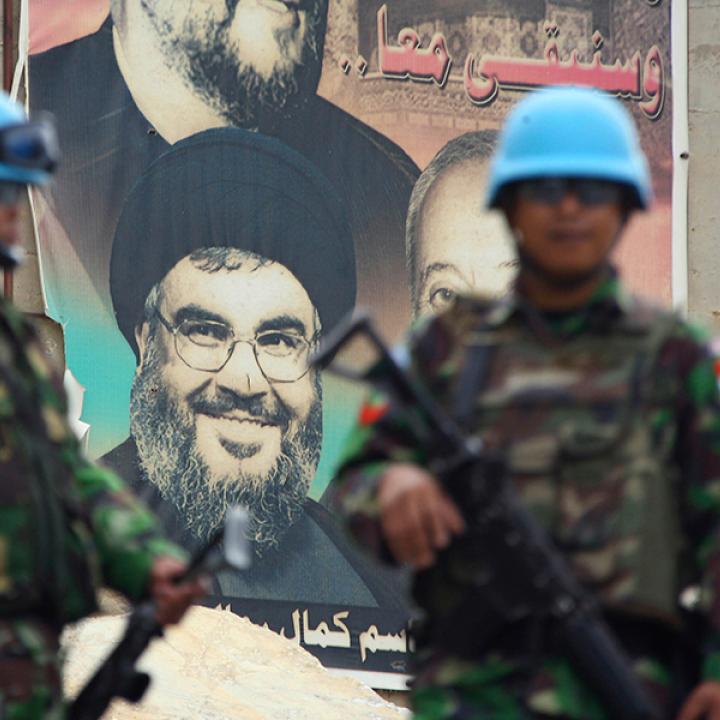 UNIFIL peacekeepers in Lebanon in front of a poster depicting Hezbollah chief Hassan Nasrallah - source: Reuters