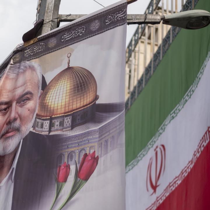 A poster depicts former Hamas leader Ismail Haniyeh alongside the Iranian flag in Tehran following Haniyeh's killing in Iran - source: Reuters