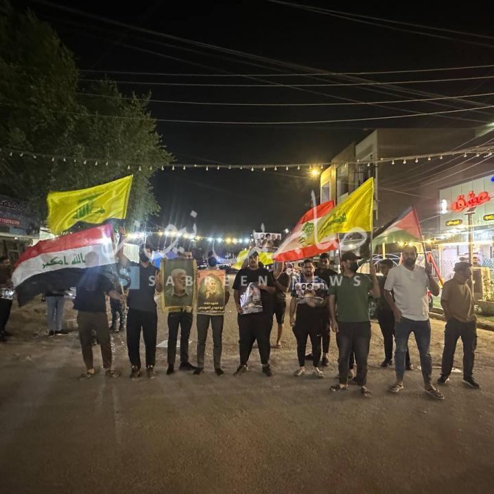 Protestors carrying Iraqi, Lebanon, and KH flags