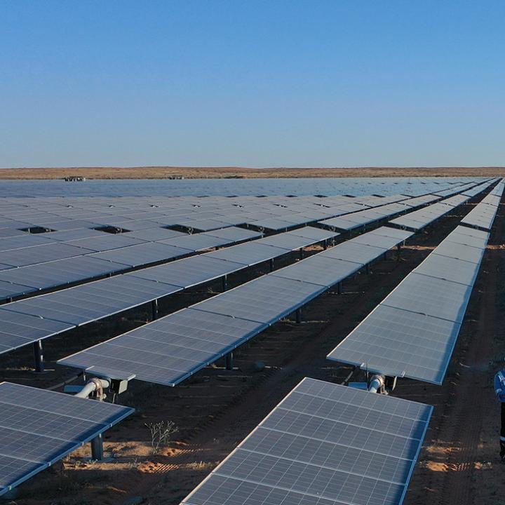 A worker monitors panels in a Saudi solar energy field - source: Kingdom of Saudi Arabia