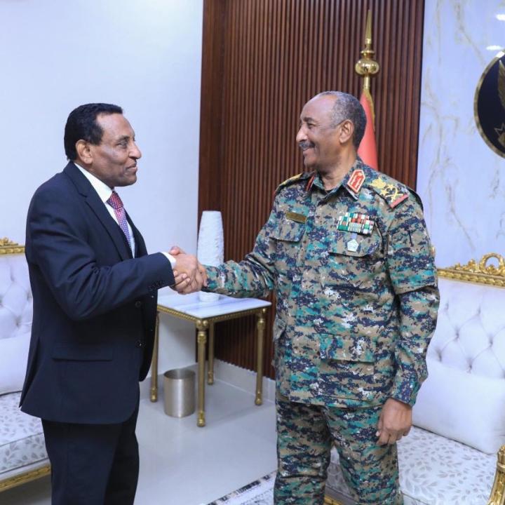 Burhan and Idris shake hands