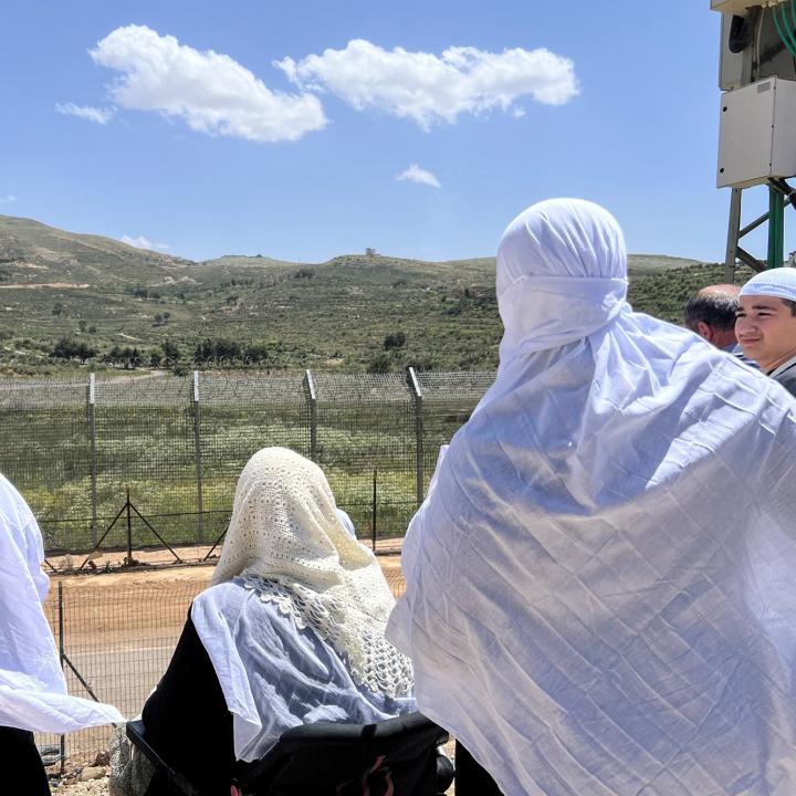 Syrian Druze women look across the Golan border into Israel - source: Reuters