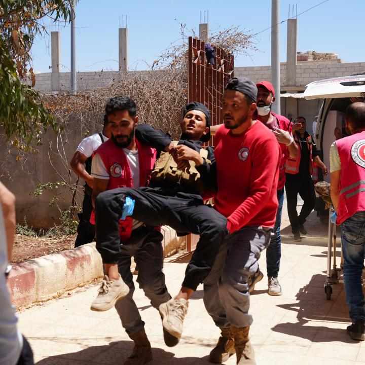 Photo of Syrian medics evacuating injured troops after violent clashes in Suwayda province..