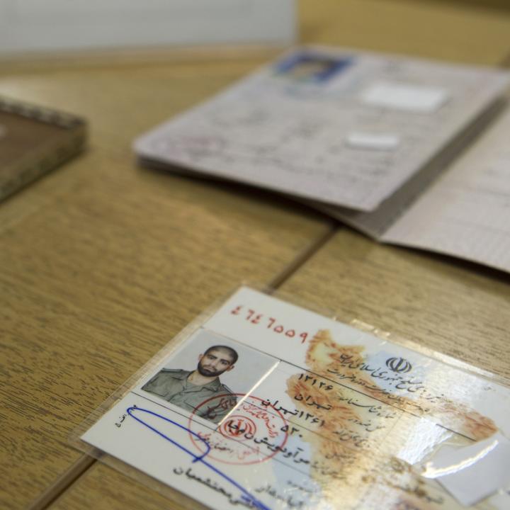 Iranian officials display what they claim to be counterfeit identification documents seized from accused spies - source: Reuters