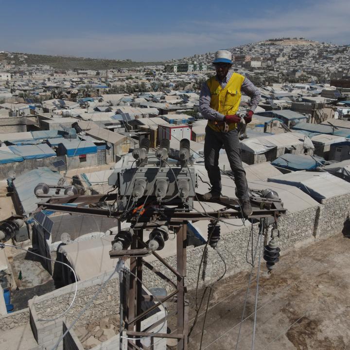 A utility worker repairs electric transmission lines in the Syria's Idlib province - source: Reuters
