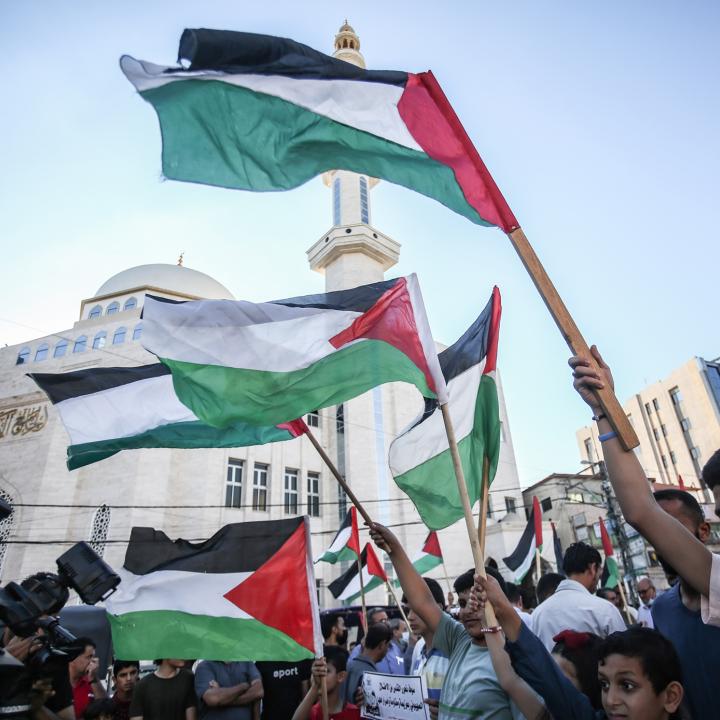Protesters wave Palestinian flags in Gaza City - source: Reuters