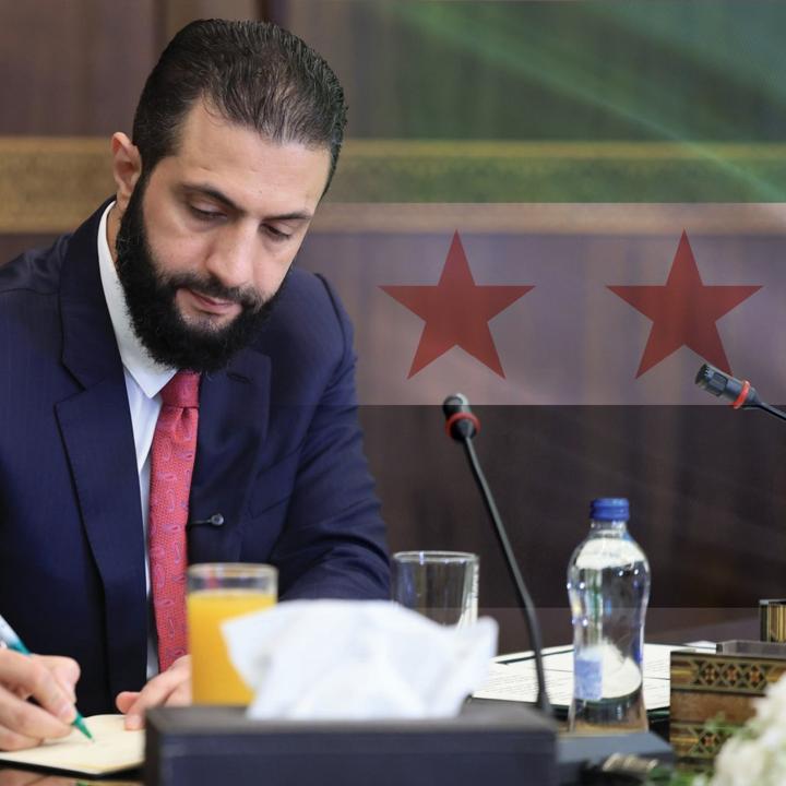 Syrian President Ahmed al-Sharaa places his signature at a cabinet meeting in Damascus, October 12, 2025.