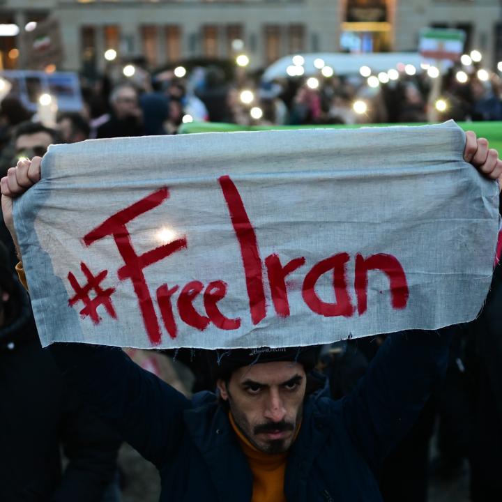 A protester holds a #FreeIran banner in Berlin - source: Reuters