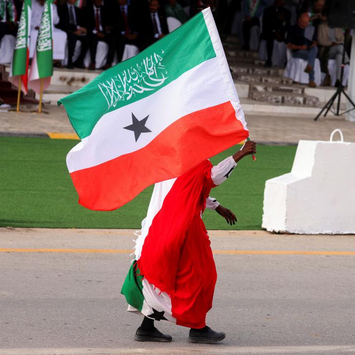 A man carries a Somilaland flag in a parade in Hargeisa - source: Reuters