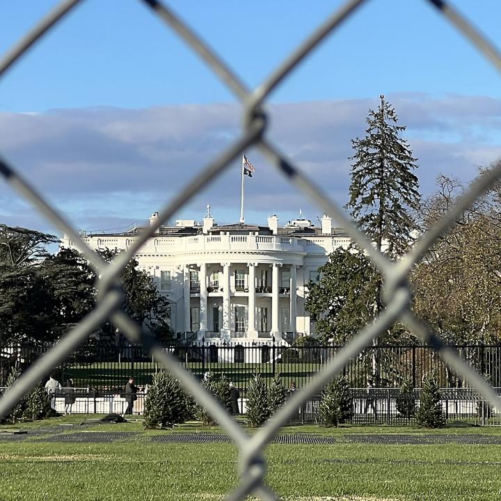 The White House photographed from behind a chain-link fence - source: Reuters
