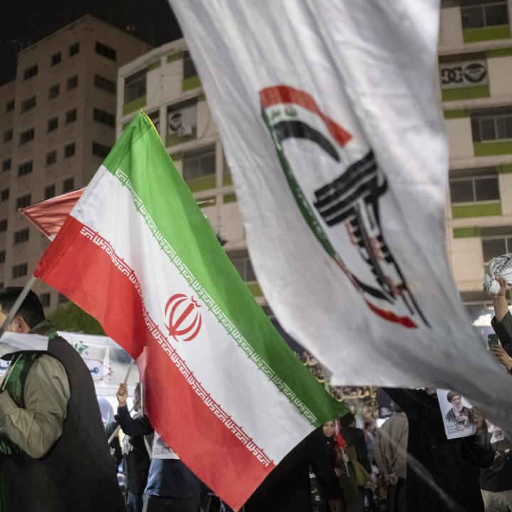 Iraqi protesters display Iranian and Popular Mobilization Forces militia flags at a demonstration in Baghdad following the killing of Iranian Supreme Leader Khamenei - source: Reuters