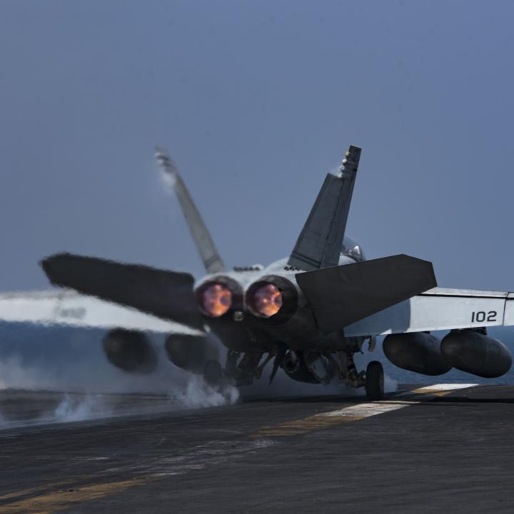 A US Navy F-18 lands on a carrier flight deck - source: Department of Defense